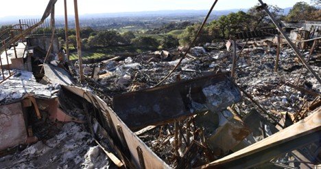 The aftermath of the fire reveals extensive structural damage and the significant loss potential associated with large-scale industrial storage facilities.