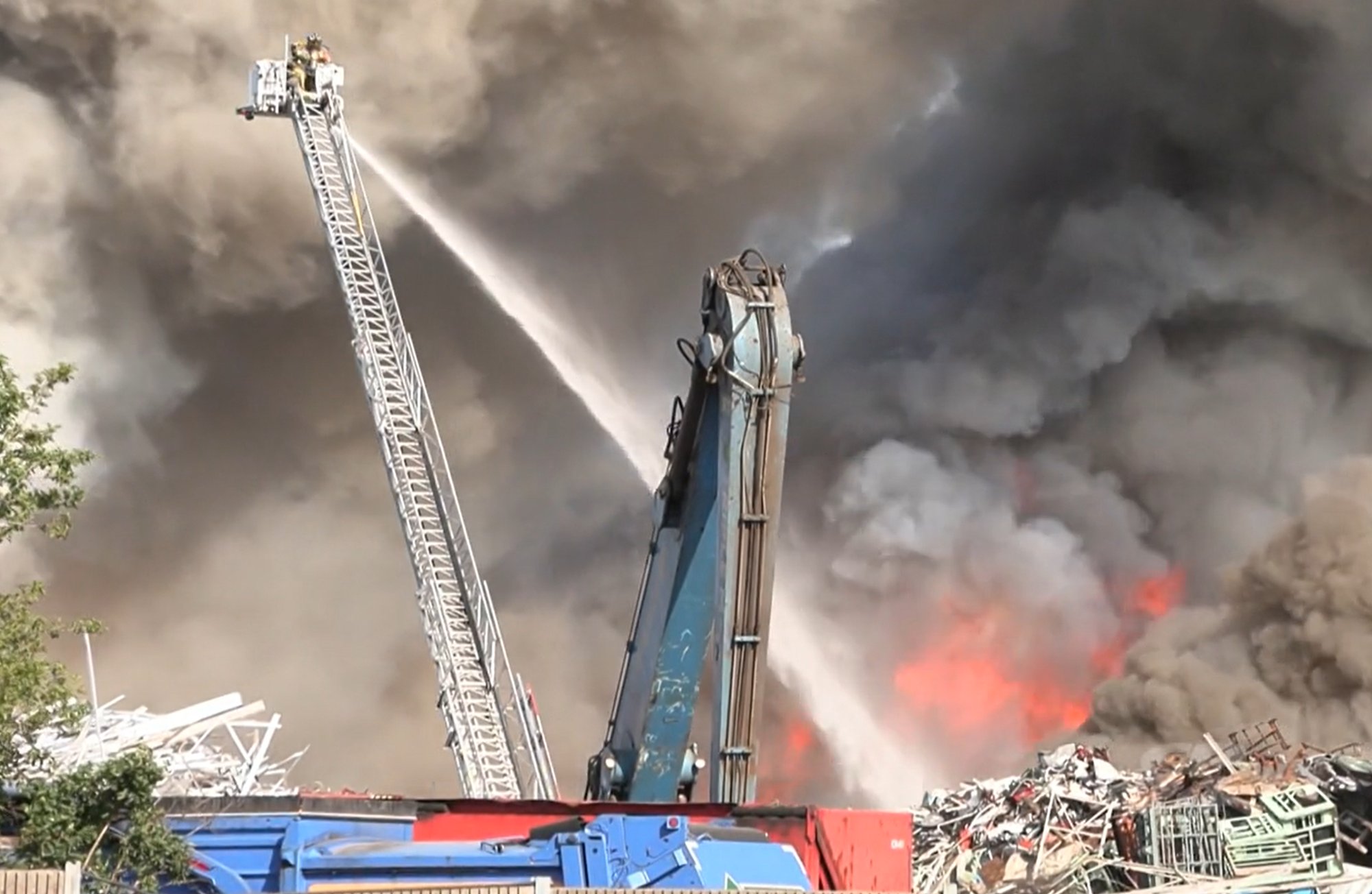 Elevated master stream operations attack a scrap metal pile fire