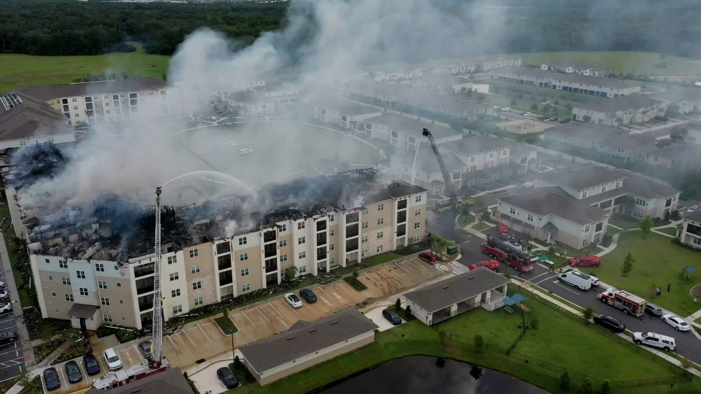 Extensive roof and structural damage visible following the apartment fire