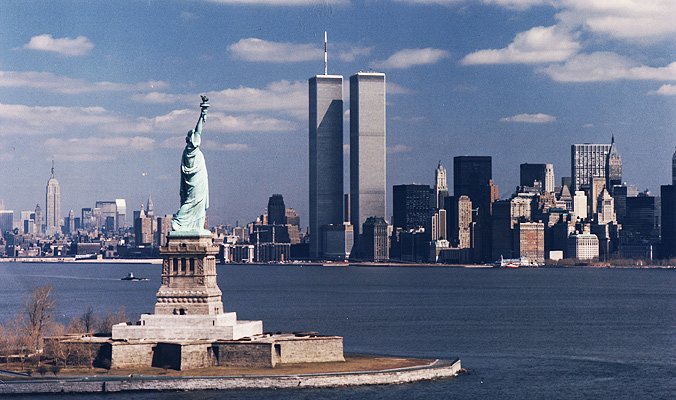 The World Trade Center Twin Towers behind the Statue of Liberty