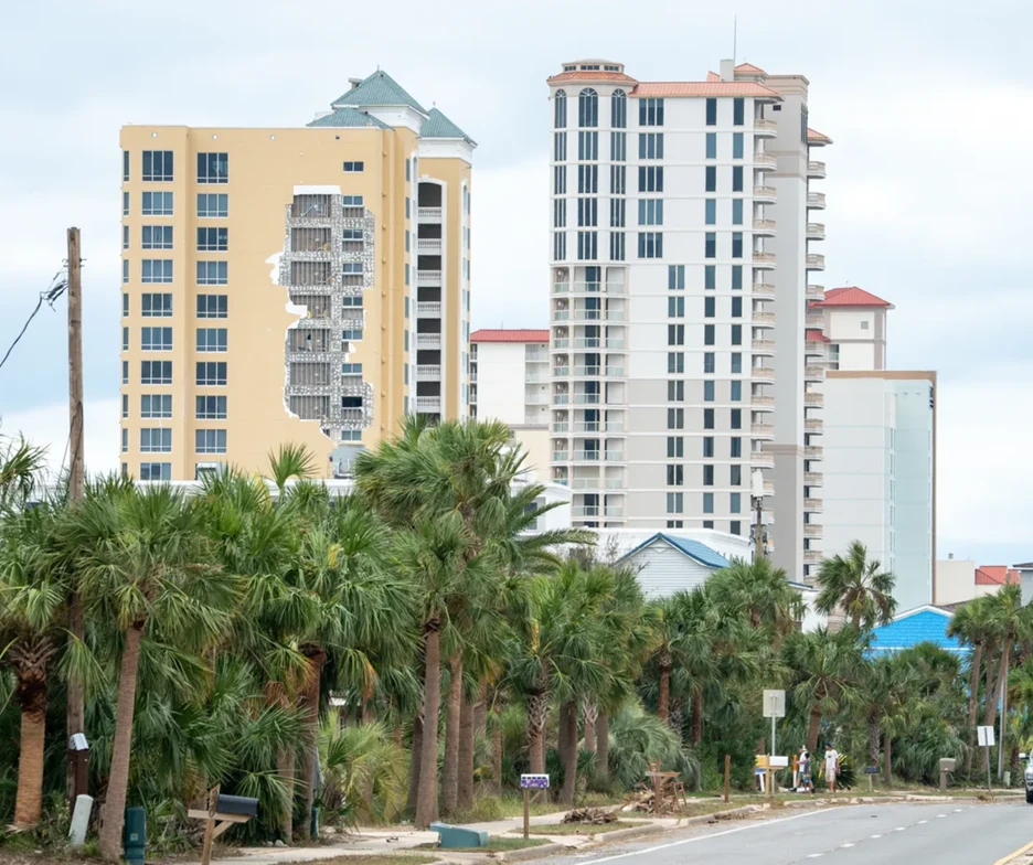 Wind damage to EIFS cladding on a coastal building following a hurricane